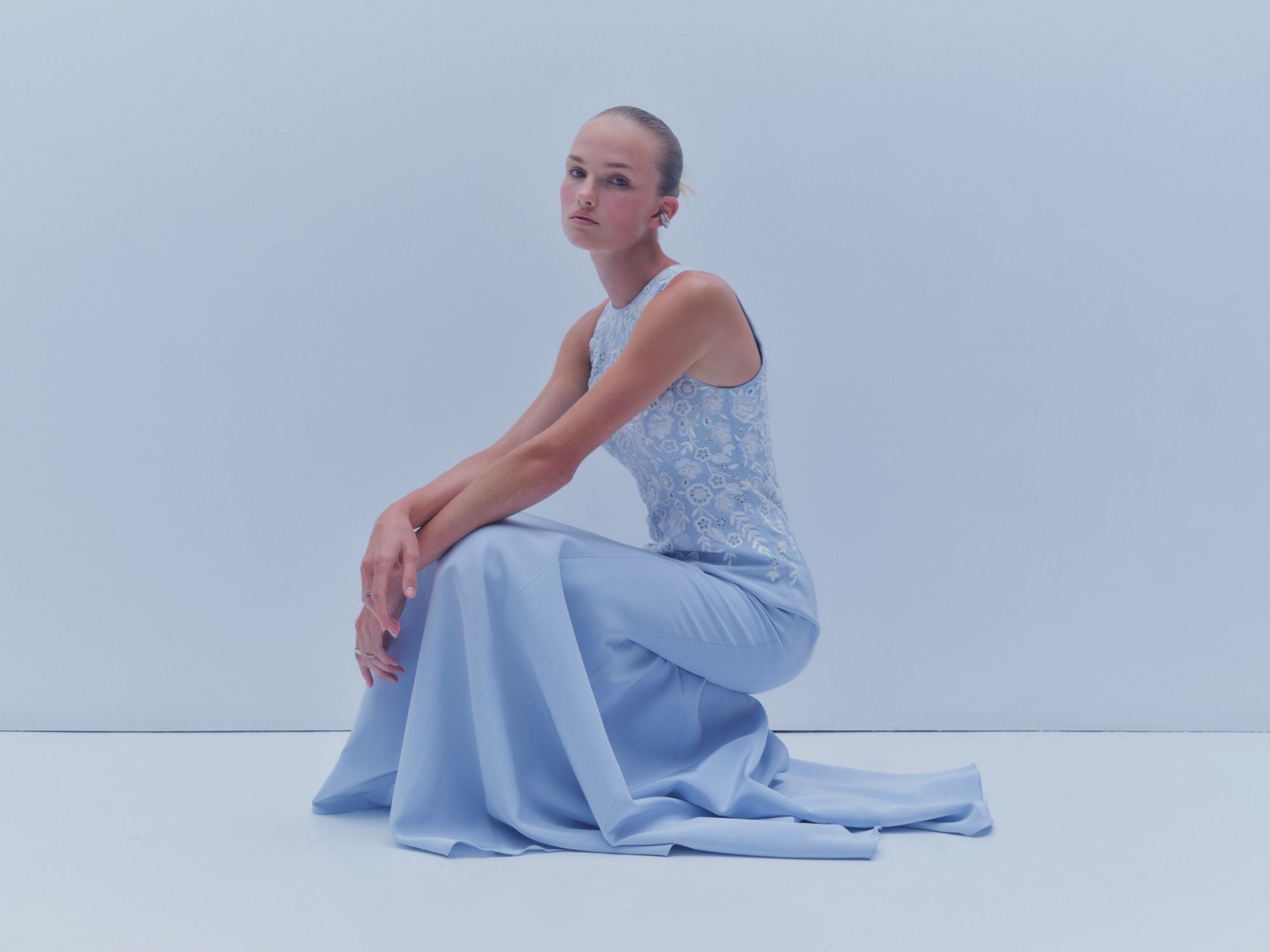 Light blue SS26 halter gown with embroidered bodice and flowing skirt by Danarys New York
